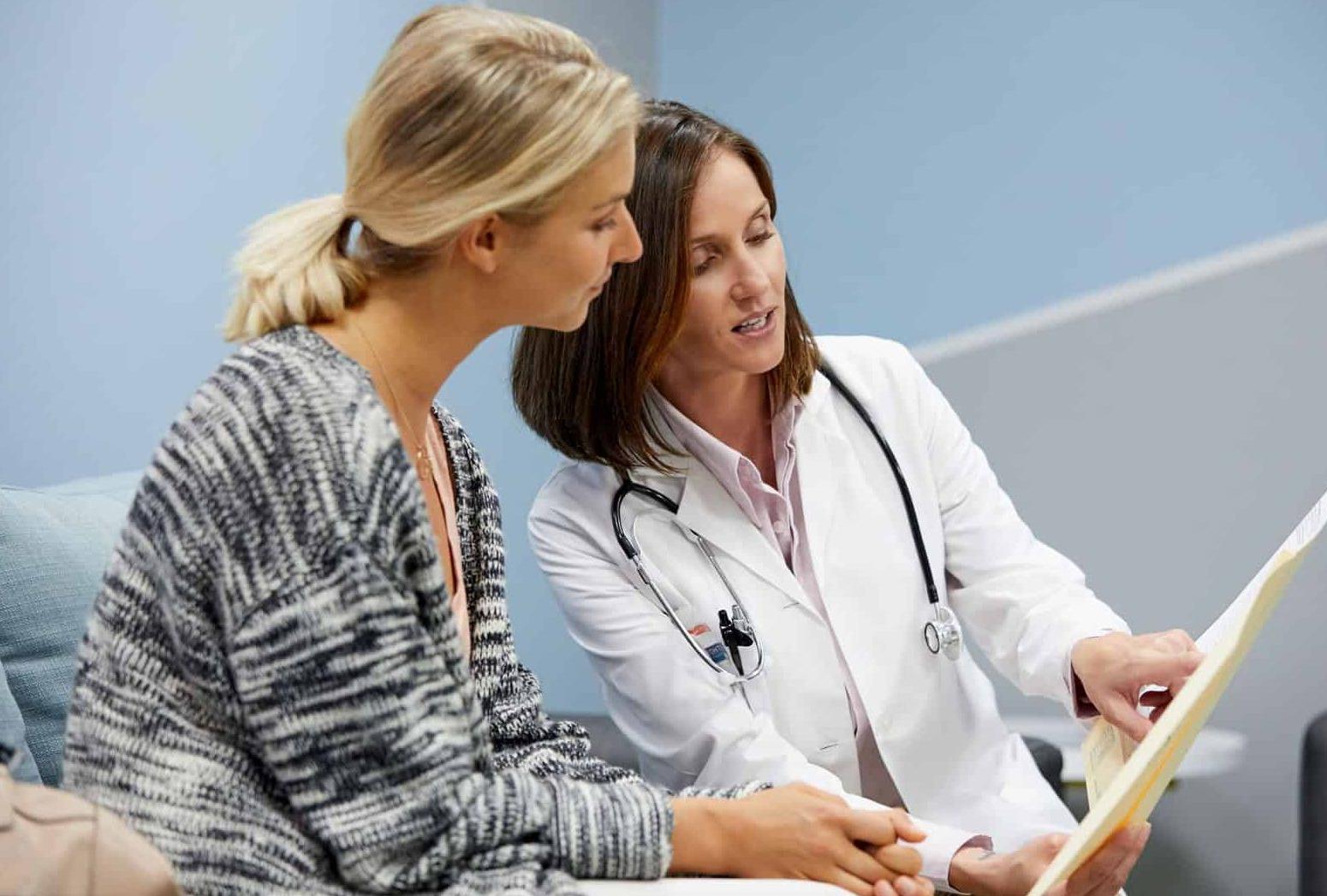 doctor showing woman papers